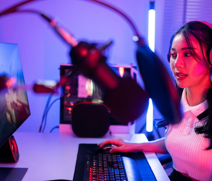 Asian beautiful Esport woman gamer play online video game on computer.