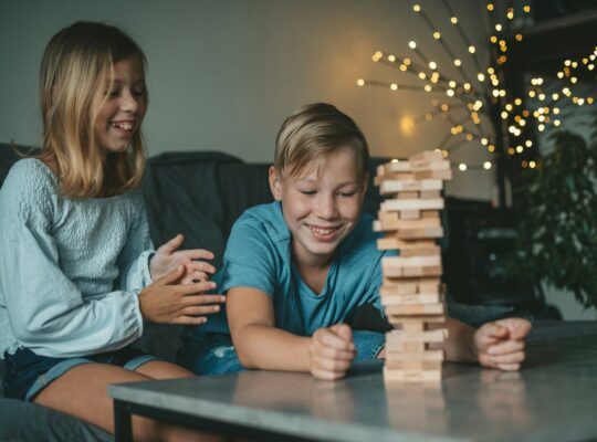 children play a game with wooden blocks