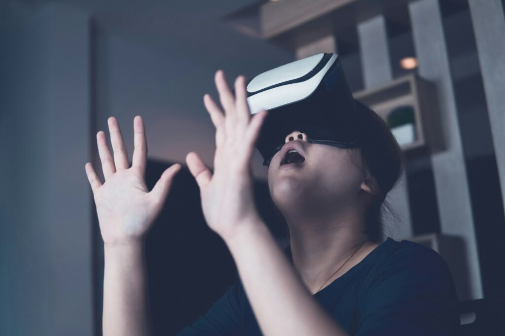Girl wears VR glasses and is excited about playing games. future technology